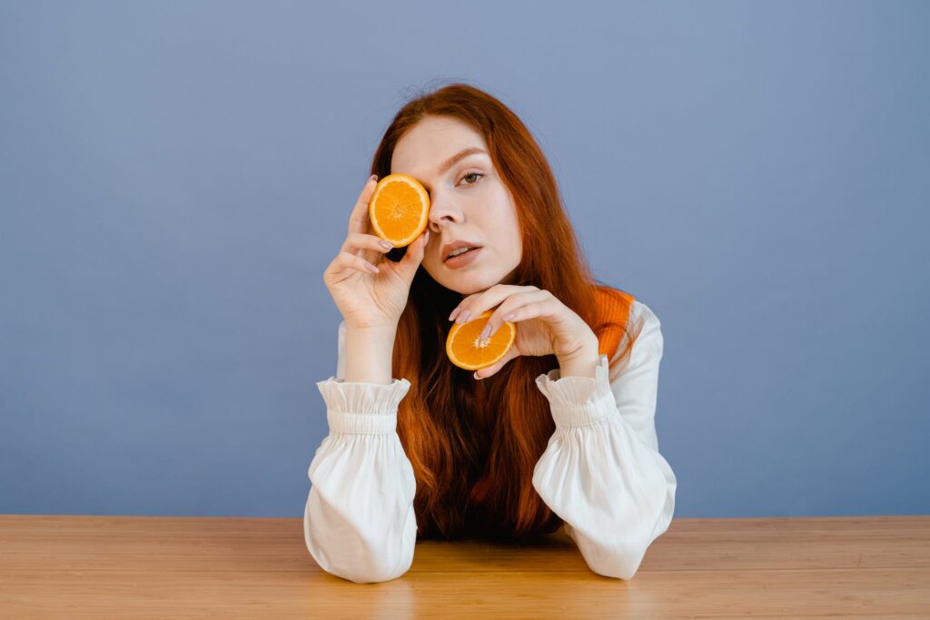 Woman Holding Sliced Oranges
